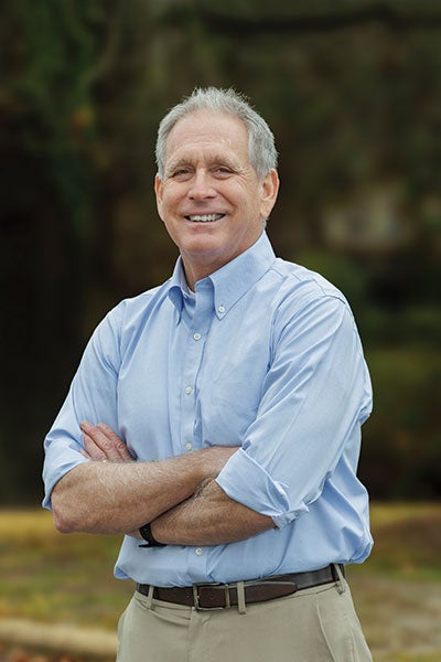 A man in a blue shirt standing.