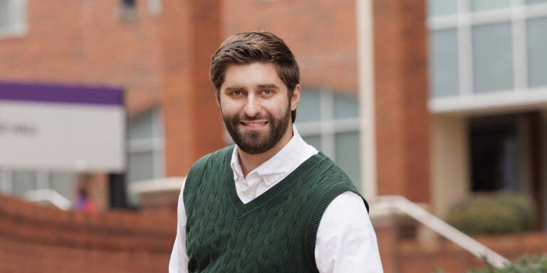 A bearded man in a green sweater.