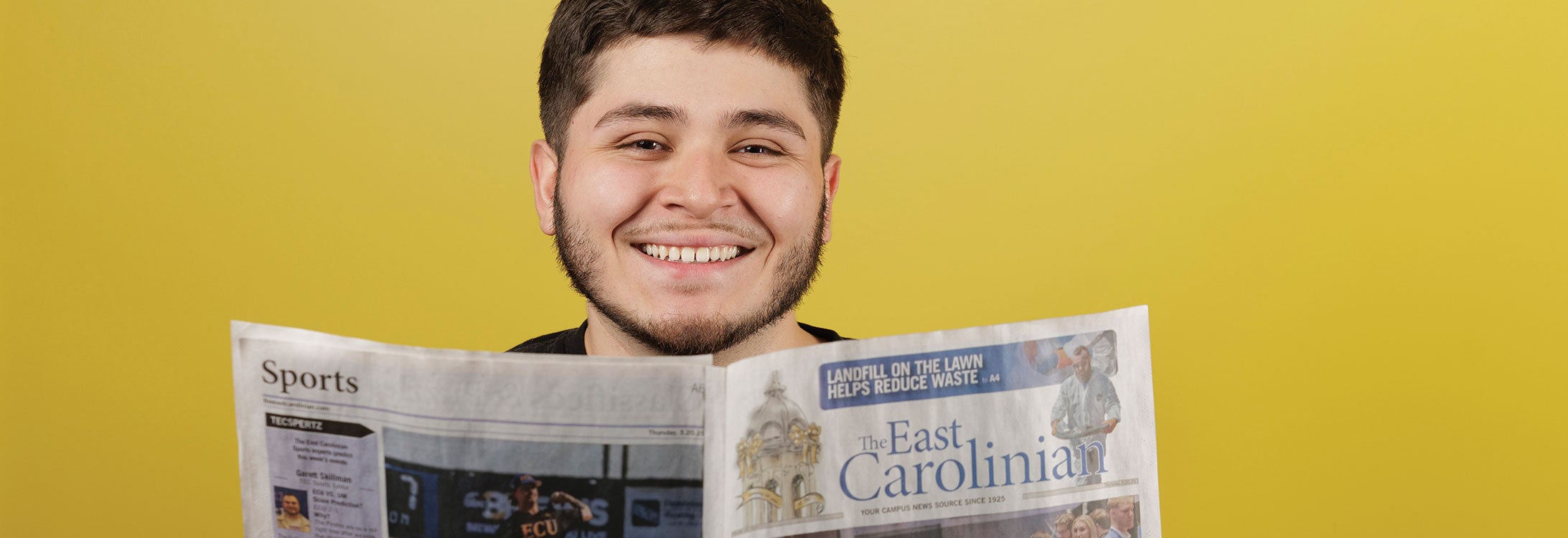 A man reads the East Carolinian newspaper