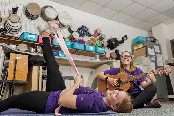 Students play with musical instruments.