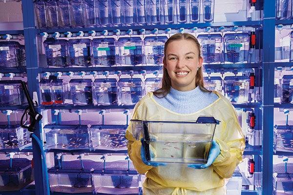 A woman with many tanks of fish
