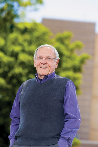An elderly man in a sweater.