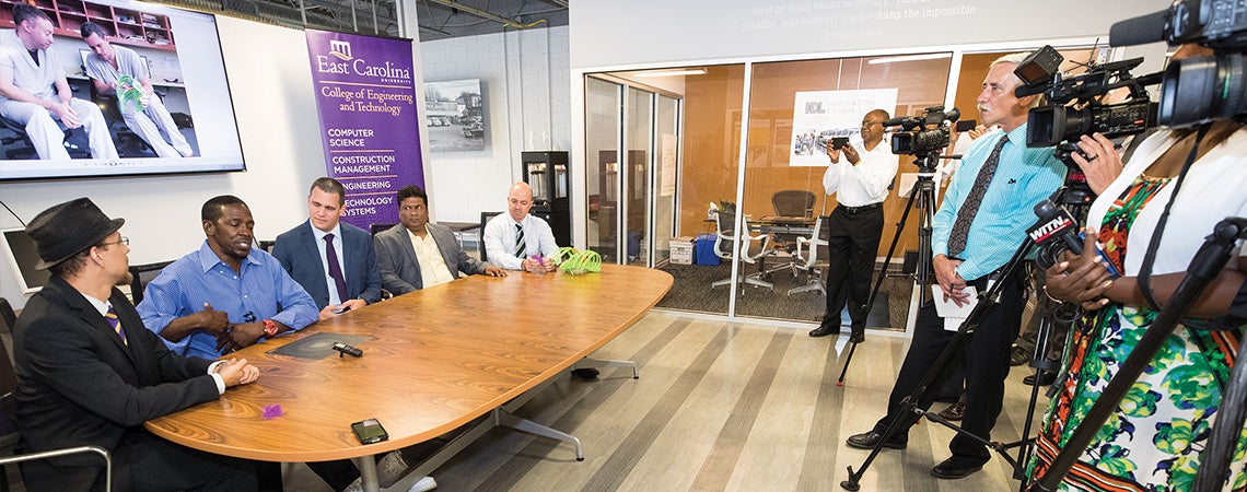 ECU student Joshua Bruce Stevens, patient Franklin Arnold and Dr. Carlos Anciano are shown during a news conference with the 3-D ribcage Stevens created.