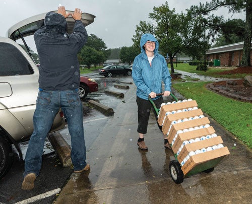 ECU medical student Holly Pittard unloads water at the Walter B. Jones Center in Greenville.