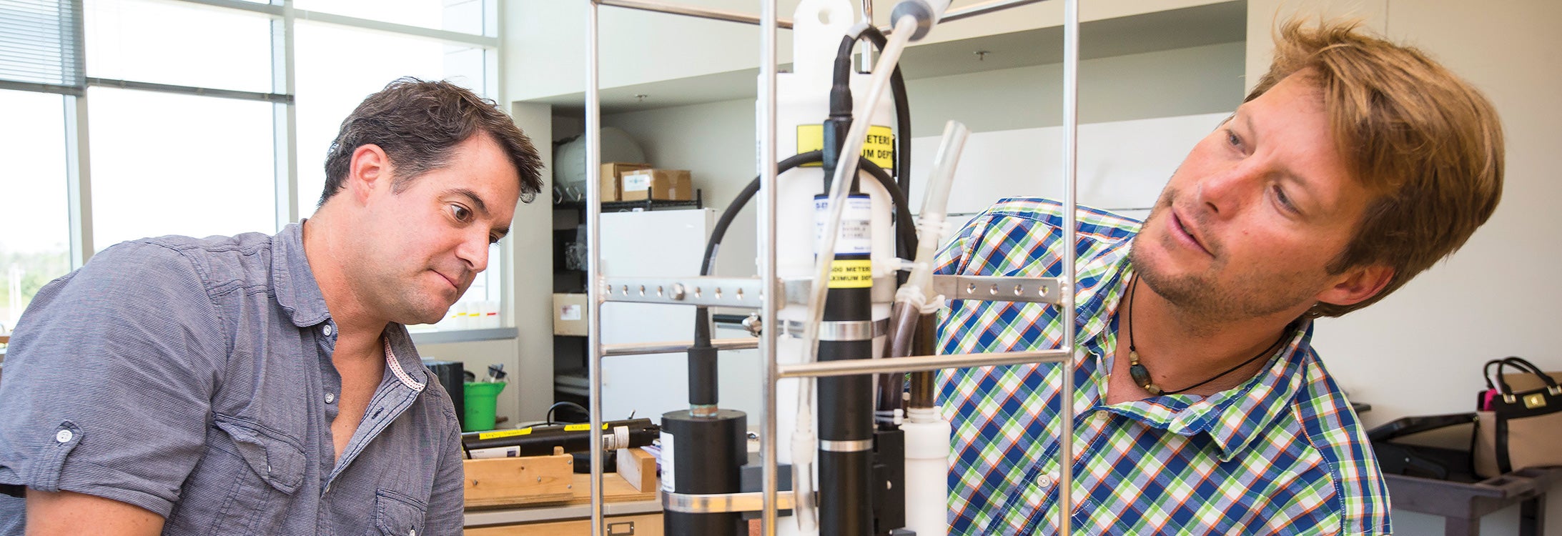 ECU geology professors J.P. Walsh, left, and Reide Corbett work with an instrument in a lab at the University of North Carolina Coastal Studies Institute.