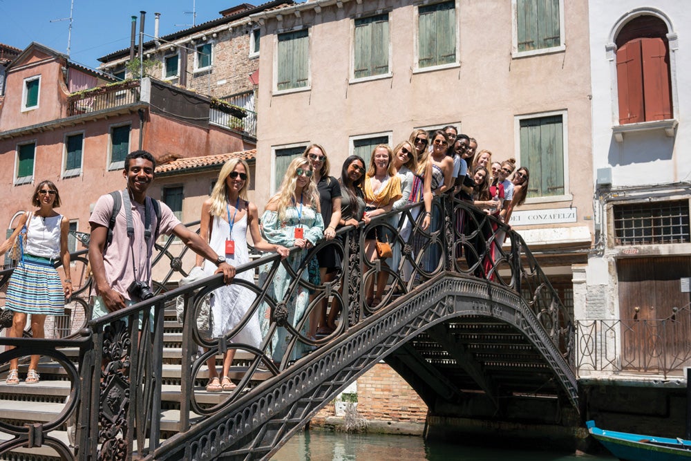 Students in the second summer 2018 session pose on one of the more than 400 bridges, which cross more than 150 canals, in Venice. The students often tell Linda Darty, the director of the ECU Tuscany program, that Venice is one of their favorite cities to explore. Above right, junior Brooke DiGregorio of Mahopac, New York, listens during a class.