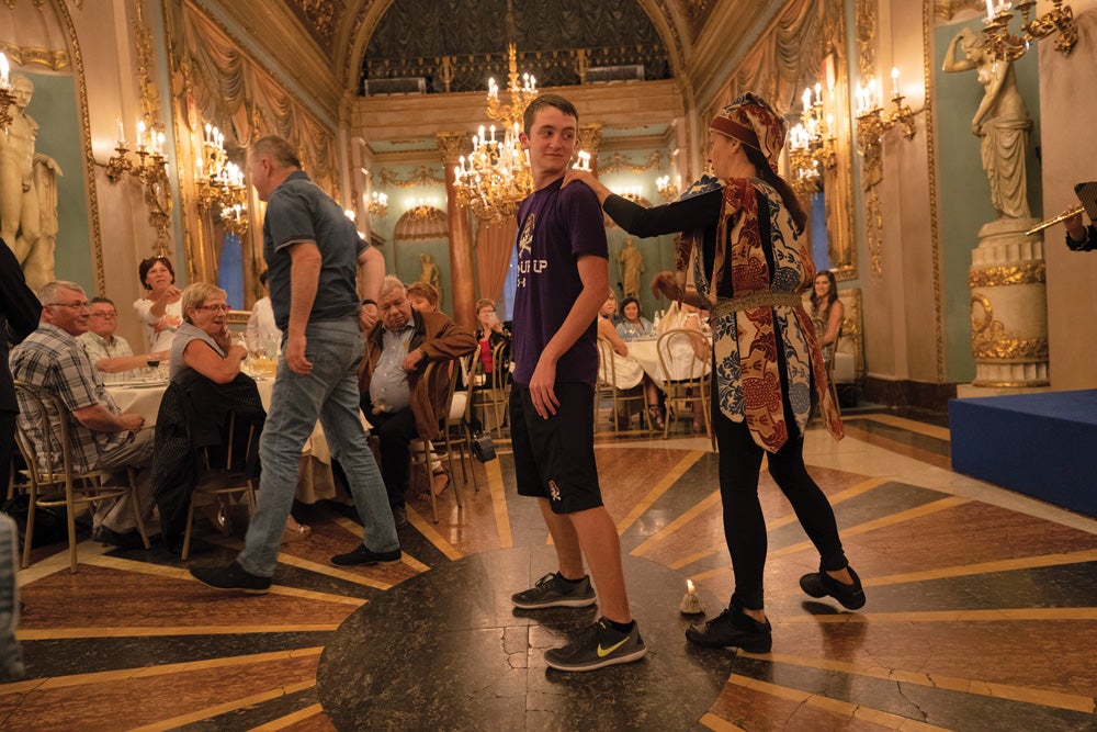 Sophomore Wesley Sanchez of Greenville waits to see what the jester has in store for him during a Renaissance-themed dinner at Palazzo Borghese in Florence.