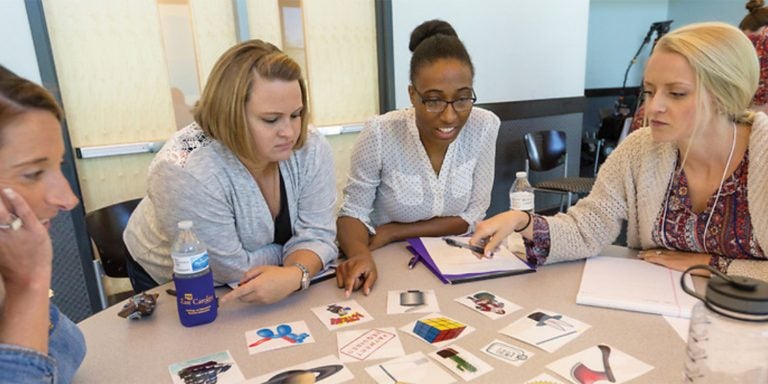 From left, students
Elisabeth Jones
(special education),
Amanda Fabritius
(special education),
Jazmin Alston
(school psychology)
and Whitney Briggs
(speech-language
pathology) participate
in the CONVEY
summer institute in
June at ECU.