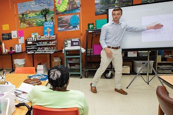 ECU engineering student Austin White gives a presentation to Farmville Senior Center members as part of a dementia education program. 
