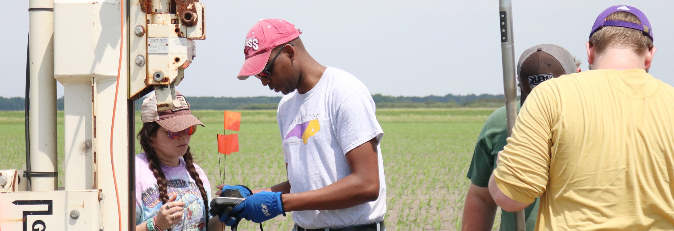 East Carolina University associate professor Alex Manda (center) takes samples in Hyde County with a team of graduate students to test soil conductivity as part of his research into saltwater intrusion. (Photo by Matt Smith)