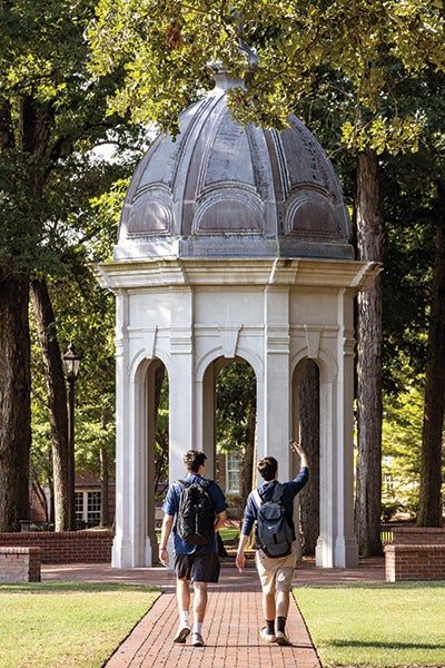 Two students walk to the cupola