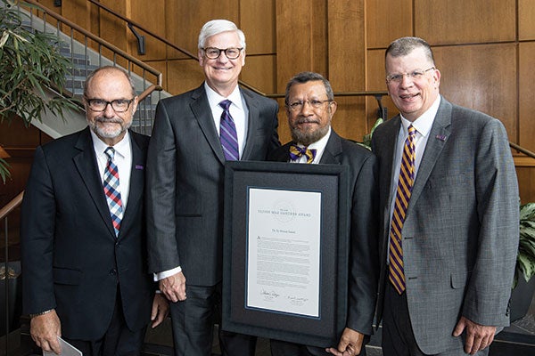 ECU Provost Ron Mitchelson, Vice Chancellor for Health Sciences Mark Stacy and Interim Chancellor Dan Gerlach (right) congratulate Dr. Sy Saeed on being named the 2019 recipient of the O. Max Gardner Award.