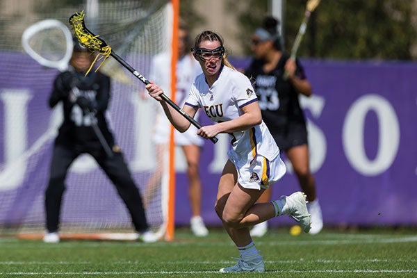 Ally Stanton looks to pass in the women’s lacrosse game against Army on March 7. The Pirates were 5-3 before the season was cut short