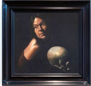 A portrait of a woman in shadow. She has dark hair and a human skull sits in front of her.