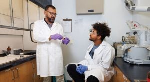 Siddhartha Mitra talking with Michael Zigah in the lab.