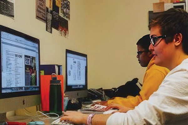 Students type at their computers