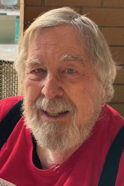 A bearded man with a red shirt.