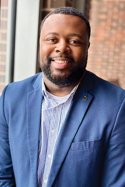 A man in a blue blazer.