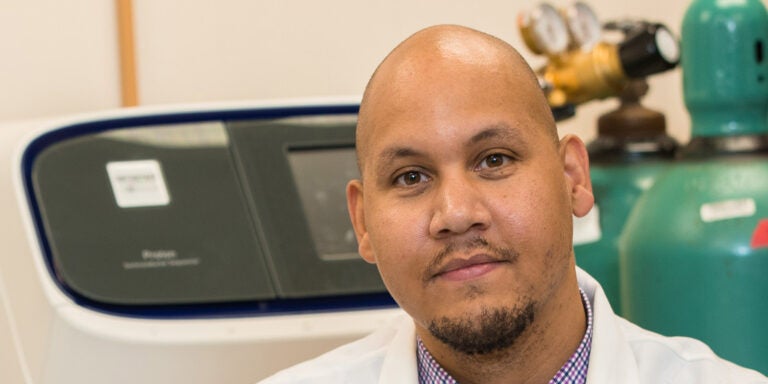A bald man in a white coat