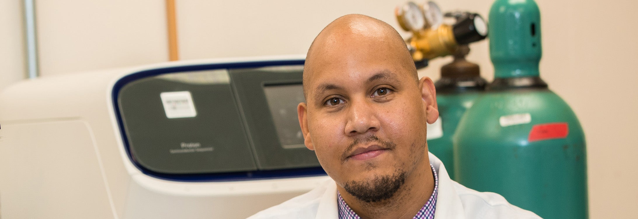 A bald man in a white coat